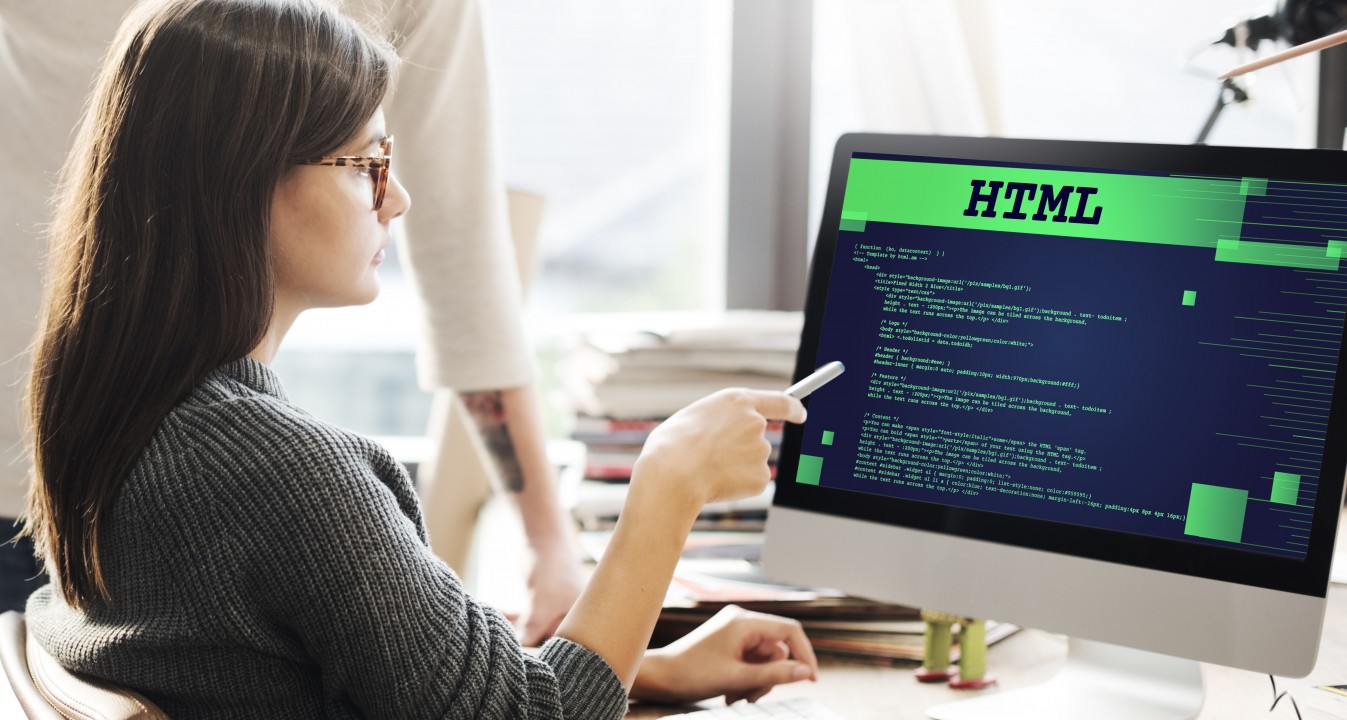 girl in front of html code