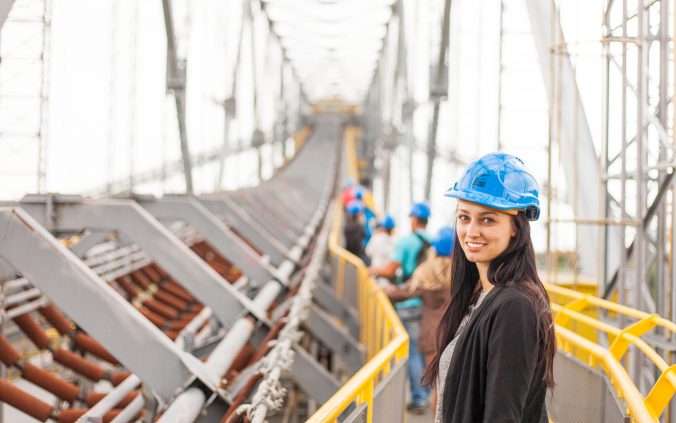 Girl wearing hard hat in construction zone